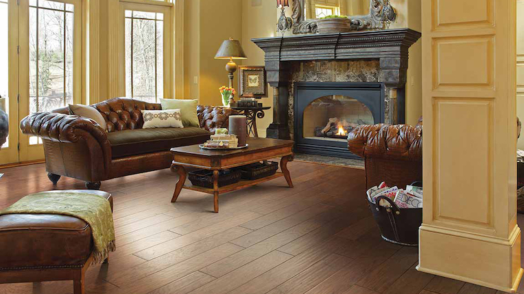 dark stained hardwood flooring in a sophisticated living room with a fireplace