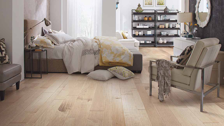 white oak wide planked hardwood flooring in a bright and cozy bedroom
